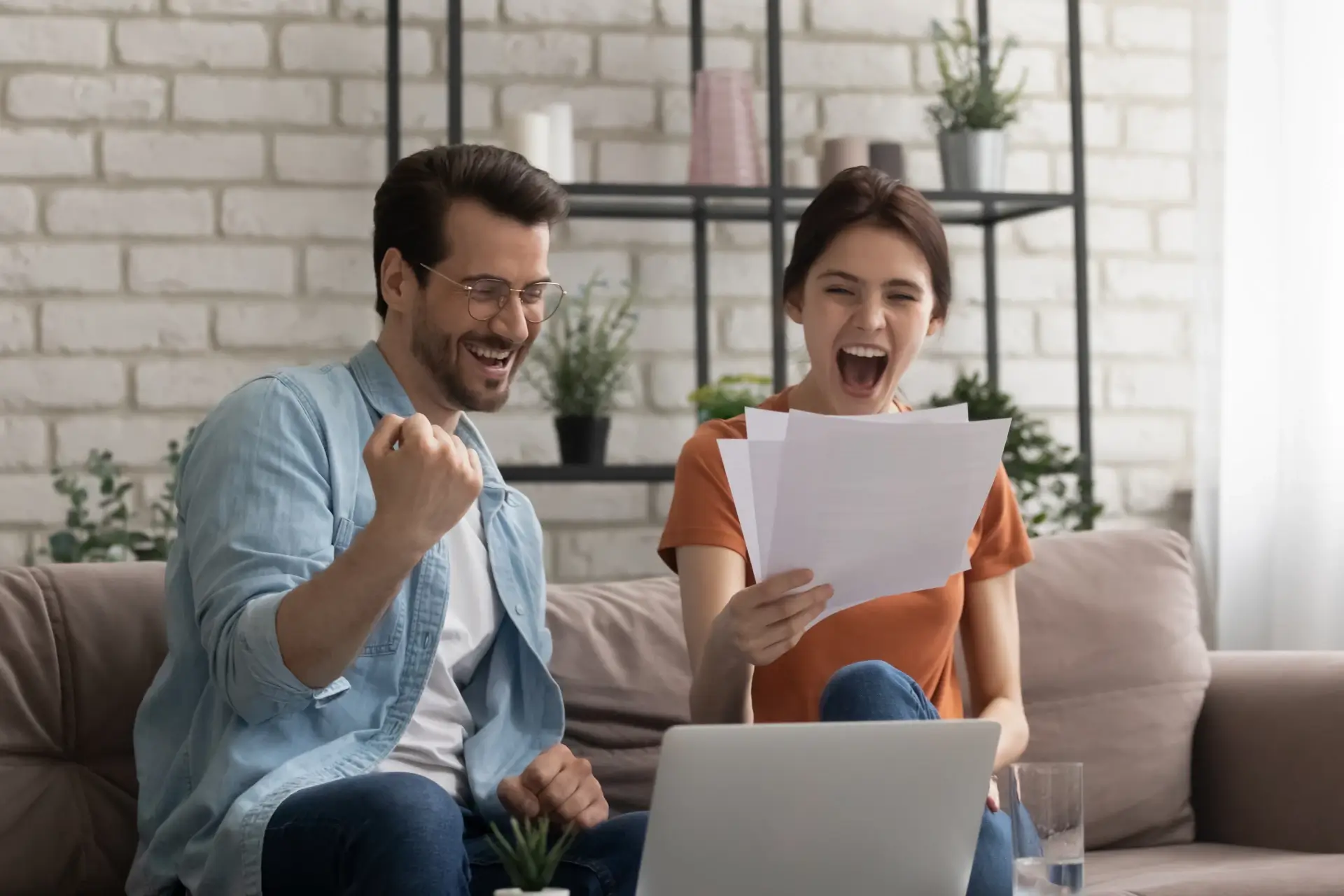 Happy couple cheering their successful new home purchase thanks to Suburban Mortgage